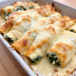 A beautifully baked dish of Spinach Cannelloni with Béchamel, showcasing golden, bubbly cheese on top of tender pasta tubes filled with spinach and ricotta.